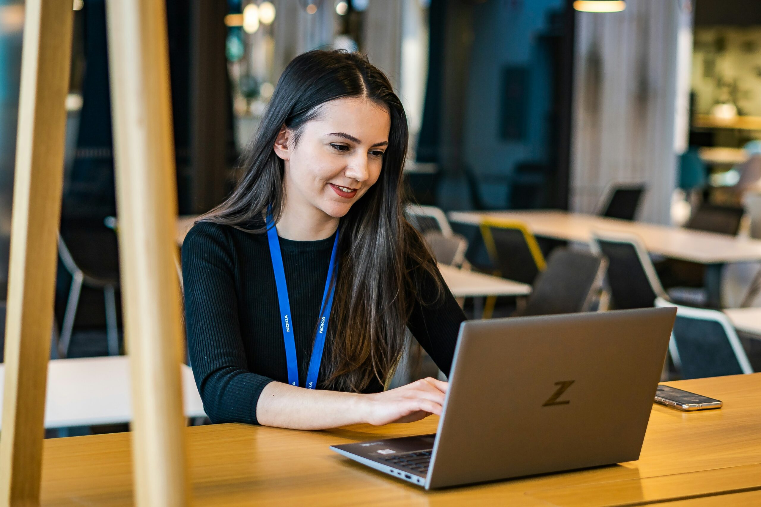 Consensus IT staff member working at a laptop