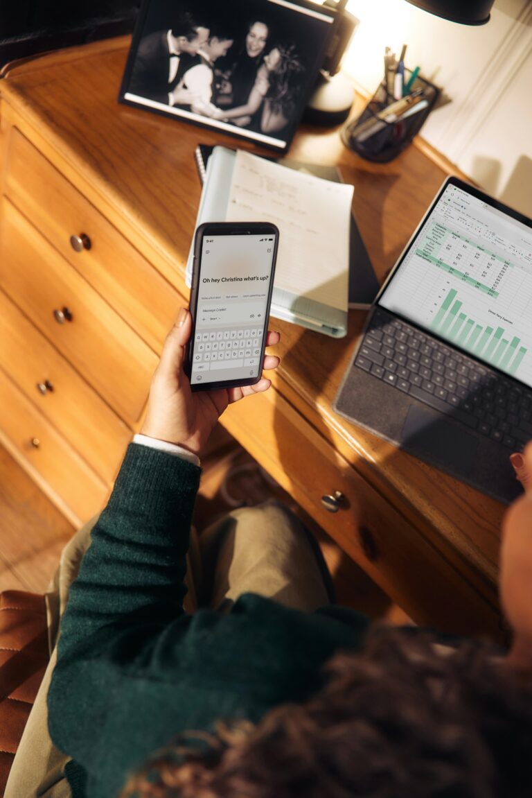 Hand holding a smartphone with Microsoft 365 and productivity apps