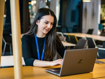 Consensus IT staff member working at a laptop